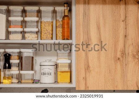 Organization of space in the kitchen cabinet. Organizers for loose products.