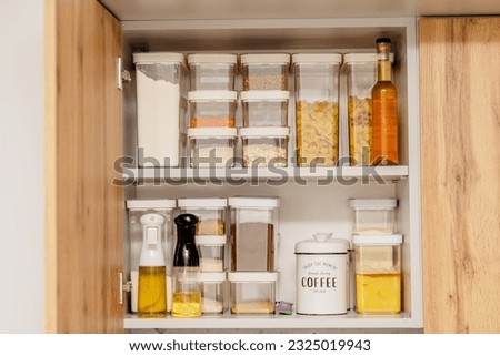 Organization of space in the kitchen cabinet. Organizers for loose products.
