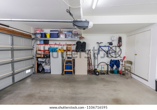Organized clean suburban\
residential two car garage with tools, file cabinets and sports\
equipment.  