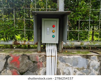 Organized electrical control panel with neatly arranged wiring and colorful red, yellow, and green buttons. Industrial electrical system showcasing safety, technology, and professional engineering installation.