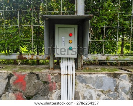 Organized electrical control panel with neatly arranged wiring and colorful red, yellow, and green buttons. Industrial electrical system showcasing safety, technology, and professional engineering installation.