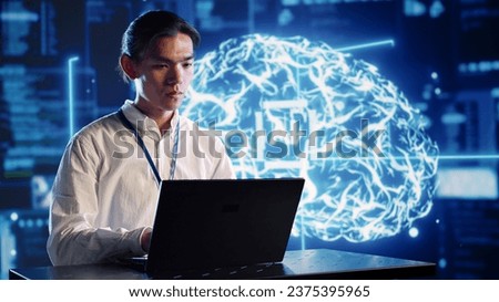 Organized engineer in high tech facility uses artificial intelligence computing simulating human brain. Dilligent admin doing operations on laptop with AI machine learning algorithms