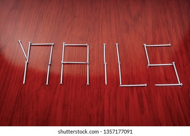 An Organized Group Of Nails Forming The Word Nails