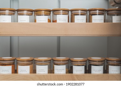 Organized, Labeled Food Pantry In Kitchen With Spices, Grains, Flours, And Rice