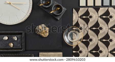 An organized overhead flat lay showcases interior design elements, including a clock, stone, textiles, and decorative items. Mood elegant