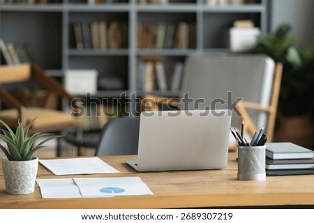 Organized place for study and research. Empty comfortable corporate or remote home office workplace. Work desk with notebook pc paper documents stationery workbooks pile prepared for project planning