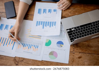 Organized stack of business documents and paperwork on office desk, representing planning, financial analysis, management, efficiency, responsibility, and deadline-focused professionalism.