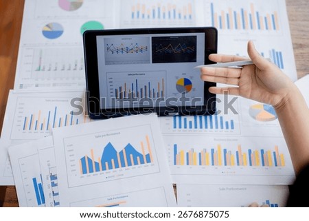 Organized stack of business documents and paperwork on office desk, representing planning, financial analysis, management, efficiency, responsibility, and deadline-focused professionalism.