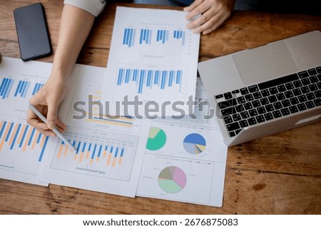 Organized stack of business documents and paperwork on office desk, representing planning, financial analysis, management, efficiency, responsibility, and deadline-focused professionalism.