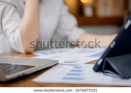 Organized stack of business documents and paperwork on office desk, representing planning, financial analysis, management, efficiency, responsibility, and deadline-focused professionalism.