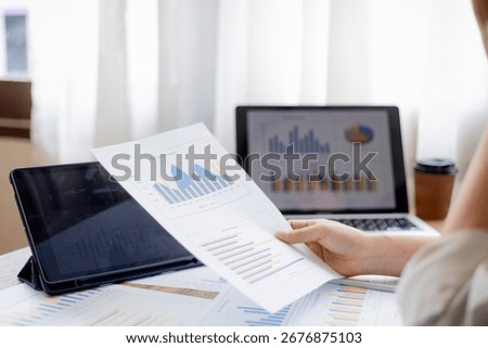 Organized stack of business documents and paperwork on office desk, representing planning, financial analysis, management, efficiency, responsibility, and deadline-focused professionalism.