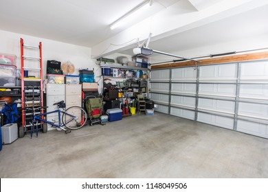 Organized Suburban Residential Garage With Shelves, File Cabinets, Tools And Sports Equipment.  