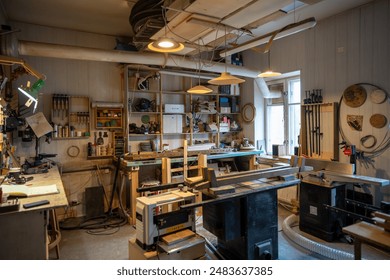 Organized tidy carpenter workplace for working with wooden products, making, creating furniture. Neat place for craftsman artisan to work with necessary accessories, tools, supplies, machines.