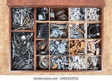 Organized Toolbox with Various Hardware Components. A top-down view of a meticulously organized toolbox filled with an assortment of hardware components, including screws and other small parts.