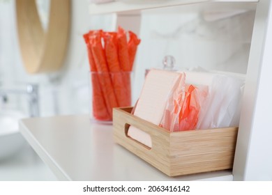 Organizer with tampons and menstrual pads on shelving unit in bathroom. Feminine hygiene products - Shutterstock ID 2063416142