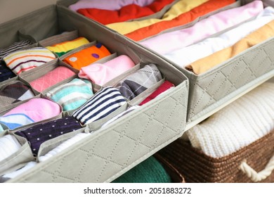 Organizers with clean clothes in closet