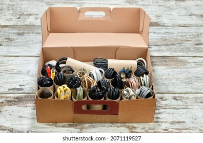Organizing power and USB cables using empty toilet paper tubes in shoebox