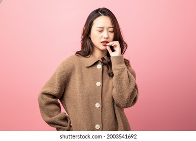 Oriental Beauty With Mouth Ulcer On Pink Background