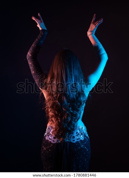 Oriental dance dancer on\
black background