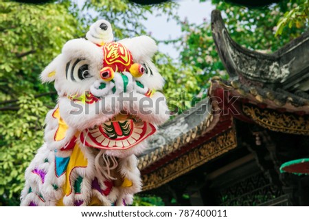 oriental lion dance in a traditional ancient Chinese garden 