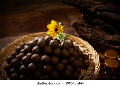 Oriental medicine pills piled up on a strainer tray. - Shutterstock ID 1995455444