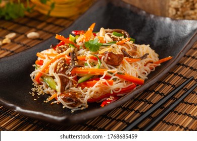 Oriental salad with rice noodles, chicken and mint. Front view. - Shutterstock ID 1768685459