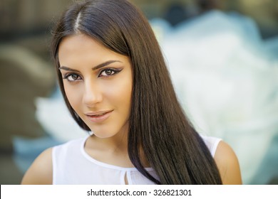 Oriental style. Sensual arabic woman model. Beautiful clean skin, saturated makeup. Bright eye make-up and dark eyeliner