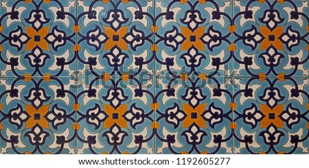Oriental tiles in blue and orange color with floral design. Yazd ancient city in middle east