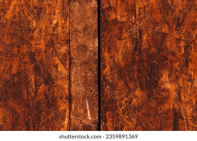 Oriented strand board (OSB) surface as background, brown painted wood - Shutterstock ID 2359891369