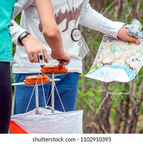 Orienteering. Check point Prism and composter for orienteering. The athlete marks the passage of the control point. Orienteering race - Shutterstock ID 1102910393