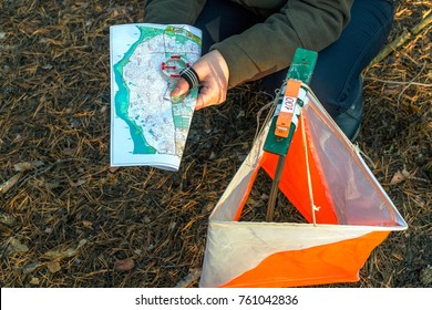 Orienteering. Compass, map, checkpoint Prism and composter for orienteering in the forest on fallen autumn needles. The concept. - Shutterstock ID 761042836