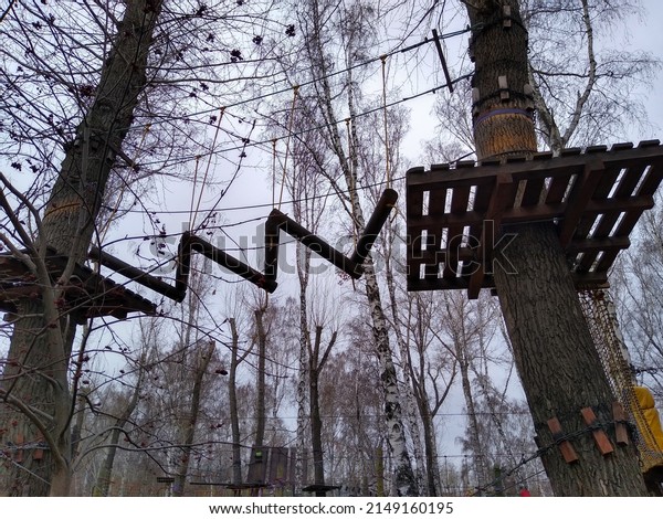 Orienteering in the park using hanging\
ladders and ropes to overcome obstacles. High quality\
photo