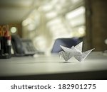 Origami bird on desk on office environment