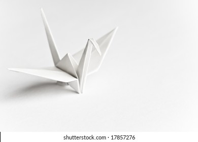 An Origami Bird On A White Background