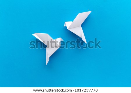 Origami birds are flying, overhead top view
