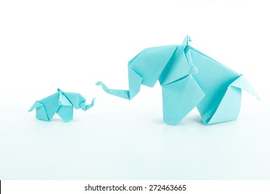 Origami blue elephant family on white background.Teaching baby elephant