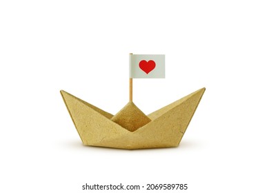 Origami Boat Made Of Recycled Paper With Flag And Heart - Concept Of Immigration And Solidarity