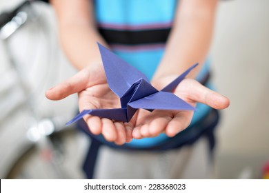 Origami Crane In Children's Hands (soft Focused)