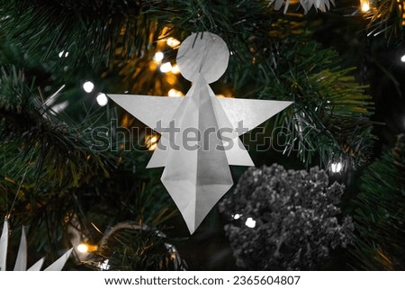 Origami decorations for the Christmas tree. Handmade, hobby Christmas tree toys. Paper crafts, handcrafts, homemade, handworks. Postcard, background for Christmas and new year. Angel and snowflake.