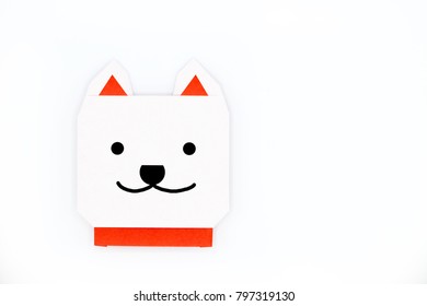Origami for kids : dog with white folded paper on white background isolated. Copy space for text.Top view, flat lay.Easy to use for card.