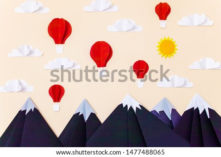 Origami mountain landscape with hot air balloons, 3d clouds and sun. Creative composition for banner/landing page/background