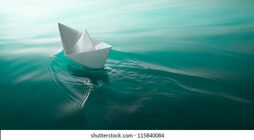 Origami Paper Boat Sailing On Water Causing Waves And Ripples