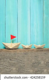 Origami Paper Boats On A Wooden Background, Summer Traveling Concept