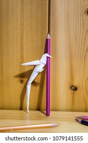 Origami, Paper Parrot Is Climbing A Colored Pencil On A Wood Shelf Composition