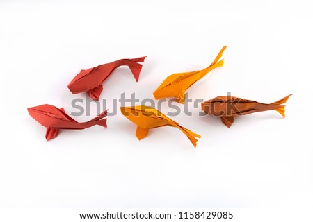 Origami paper red and yellow fishes on white background