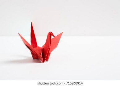 Origami Red Bird Paper On White Background.