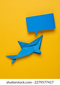 Origami shark with empty speech bubble on yellow background