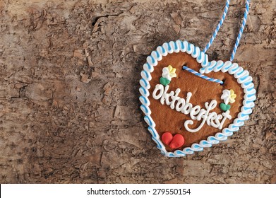original bavarian Oktoberfest gingerbread heart on real brown tree bark