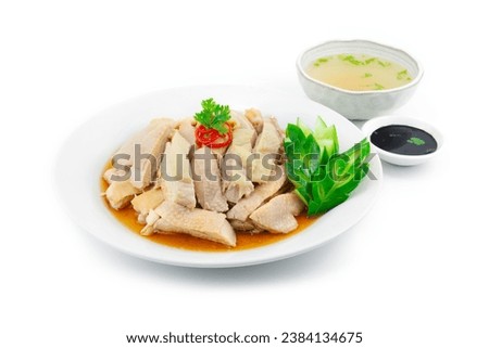 Original Cantonese Chicken Singapore Style decorated with carved Cucumber Served Clear Soup and black soy sauce sideview