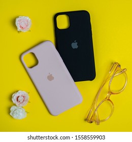 Original Cases For IPhone On Yellow Background. Apple Accessories. Flat Lay. Kiev, Ukraine 11.11.2019